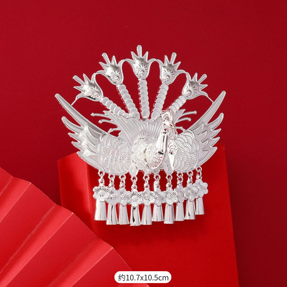 Boho vintage ethnic silver-tone hair stick (hand-held display against a rich red background alongside a red folding fan) featuring intricate openwork details and layered tassel fringe 06