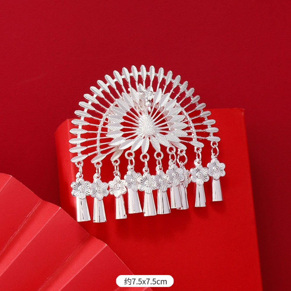 Boho vintage ethnic silver-tone hair stick (hand-held display against a rich red background alongside a red folding fan) featuring intricate openwork details and layered tassel fringe 07