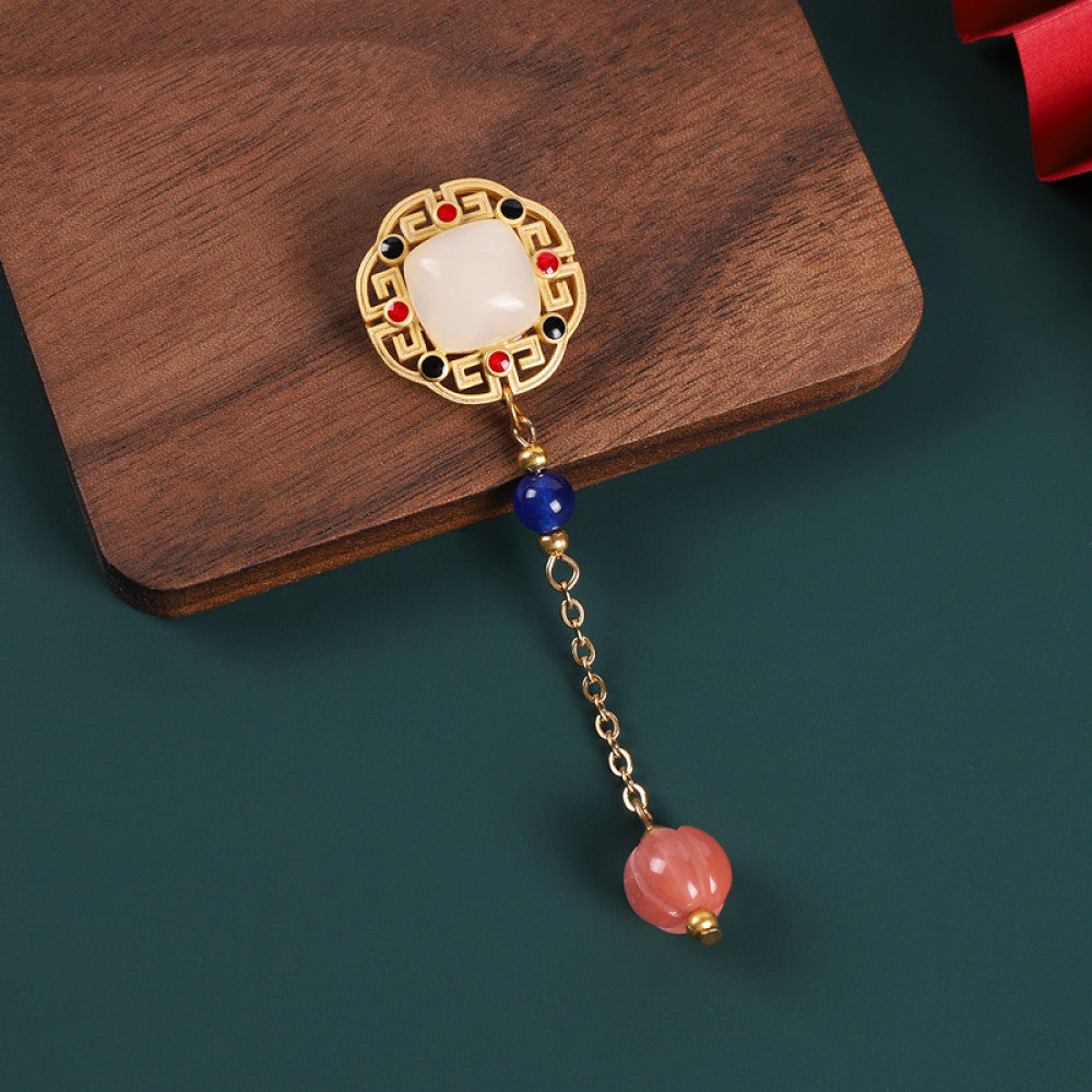Boho vintage ethnic statement brooch pendant featuring white gemstone, red accents and colorful bead tassel, styled on a wooden tray, ideal for bohemian and traditional fashion enthusiasts in the US