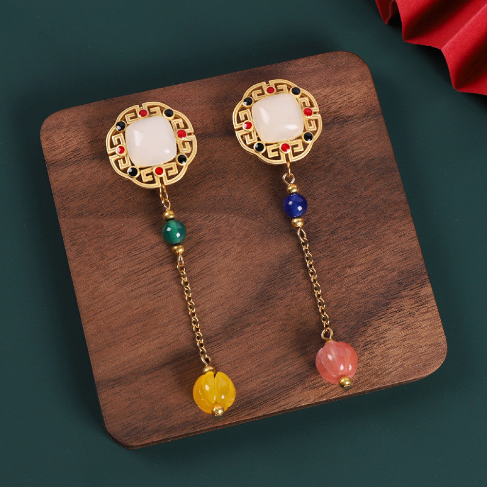 Boho vintage ethnic statement earrings set with white gemstone, colorful bead tassels and intricate frame details, styled on a wooden tray, ideal for bohemian and traditional fashion enthusiasts in the US