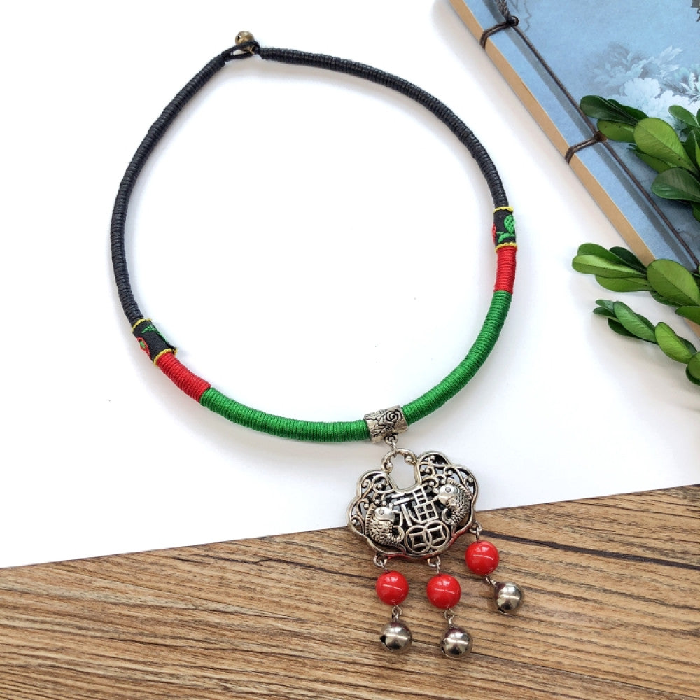 Boho vintage ethnic tri-color rope choker necklace, featuring a silver-tone ornate fringe pendant with colorful bead details, displayed on a wooden surface 05