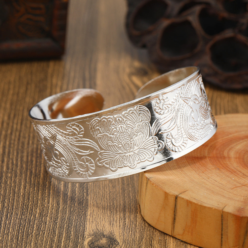 Boho vintage ethnic silver cuff bangle with tribal geometric engravings, styled on wooden surface, perfect for bohemian and tribal fashion lovers in the US 03