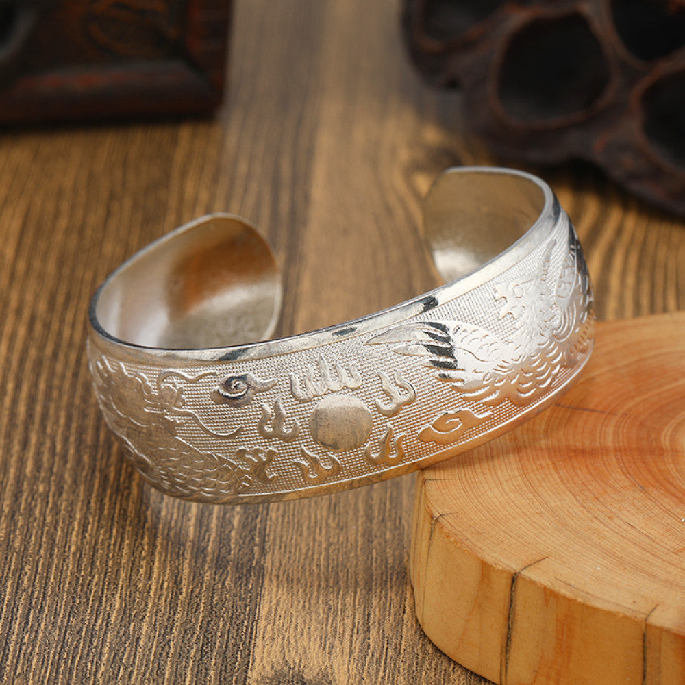 Boho vintage ethnic silver cuff bangle with tribal geometric engravings, styled on wooden surface, perfect for bohemian and tribal fashion lovers in the US 06