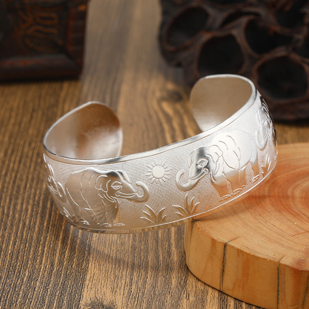 Boho vintage ethnic silver cuff bangle with tribal geometric engravings, styled on wooden surface, perfect for bohemian and tribal fashion lovers in the US 07