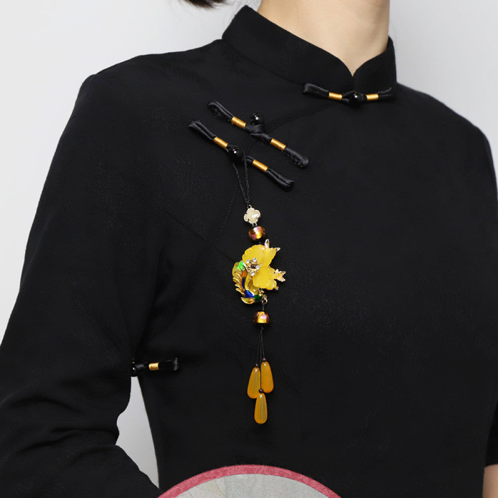 Boho vintage ethnic yellow-tone hair pendant featuring black cord, yellow flower-shaped charm (with multi-color gemstone & gold accents), and yellow teardrop pendants, styled against a black fabric background, ideal for bohemian and traditional fashion enthusiasts in the US 01