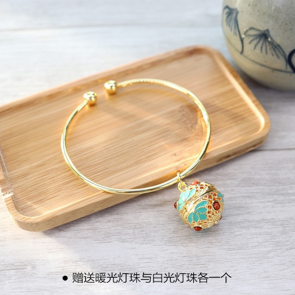 Boho vintage gold bangle with sakura locket charm, styled on wooden tray, ideal for bohemian and floral fashion enthusiasts 02