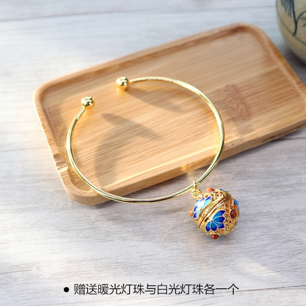 Boho vintage gold bangle with sakura locket charm, styled on wooden tray, ideal for bohemian and floral fashion enthusiasts 03