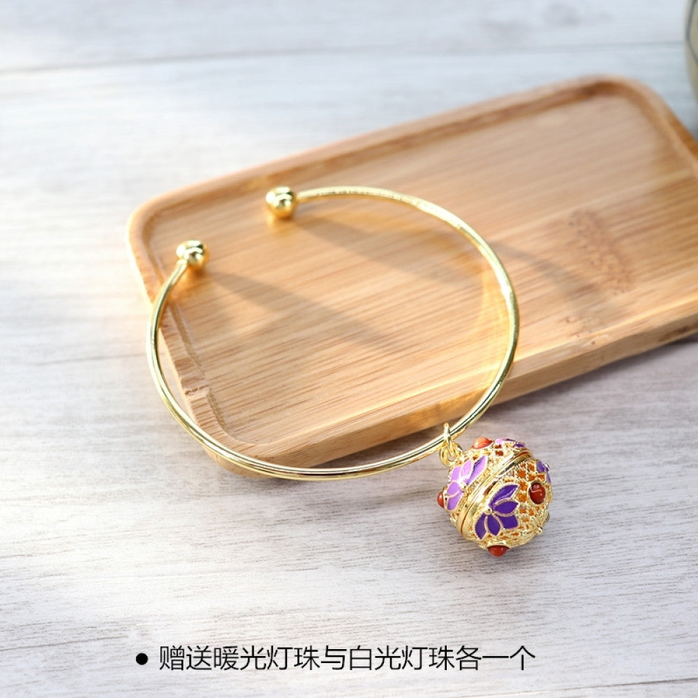 Boho vintage gold bangle with sakura locket charm, styled on wooden tray, ideal for bohemian and floral fashion enthusiasts 05