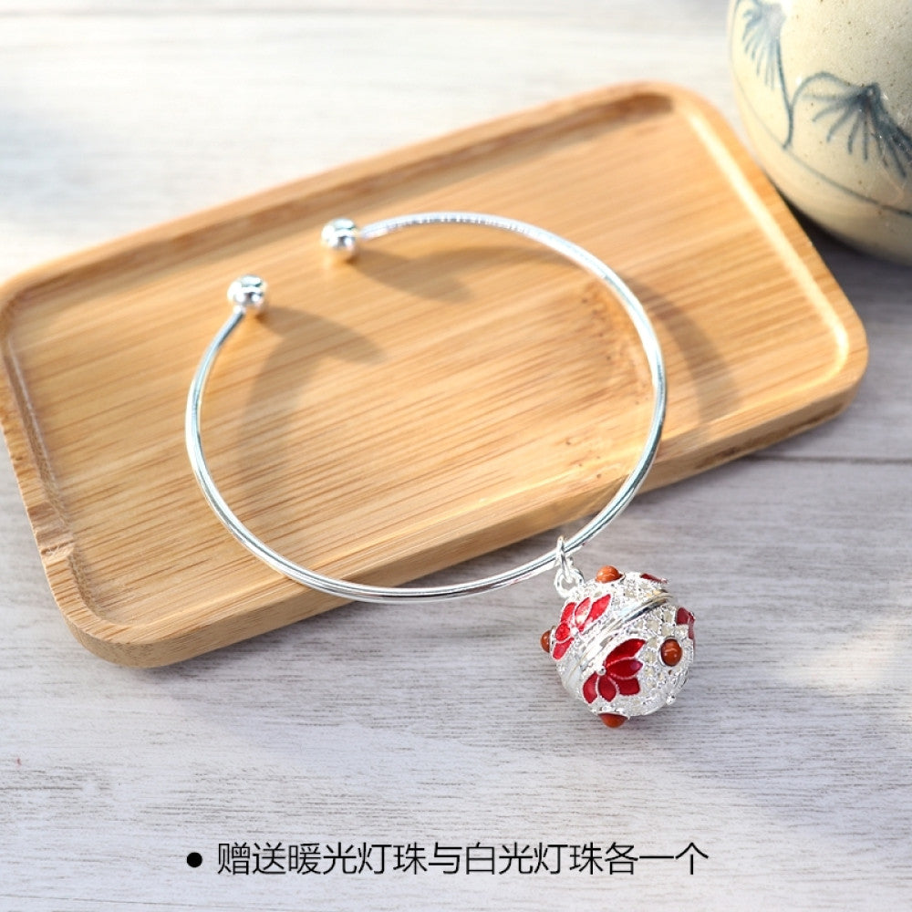 Boho vintage gold bangle with sakura locket charm, styled on wooden tray, ideal for bohemian and floral fashion enthusiasts 07