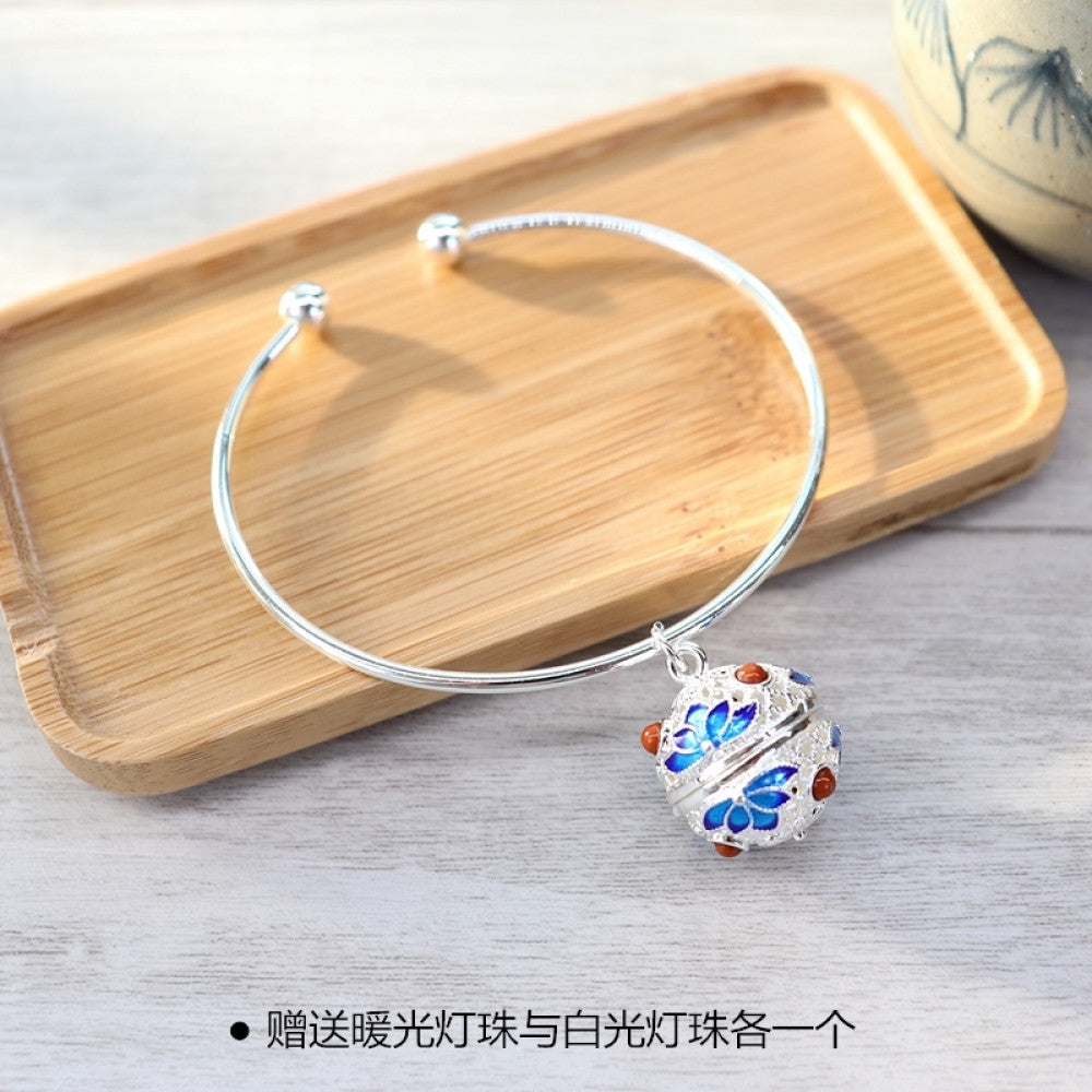 Boho vintage gold bangle with sakura locket charm, styled on wooden tray, ideal for bohemian and floral fashion enthusiasts 09