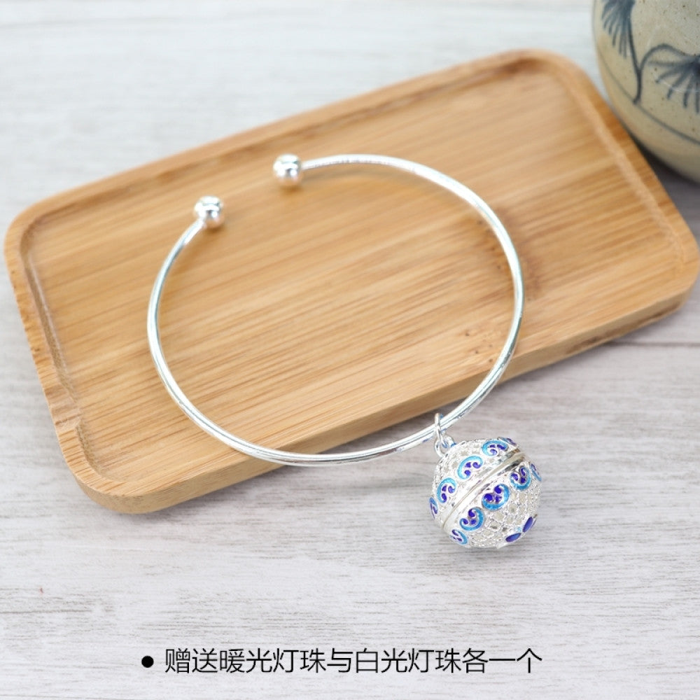 Boho vintage gold bangle with sakura locket charm, styled on wooden tray, ideal for bohemian and floral fashion enthusiasts 10