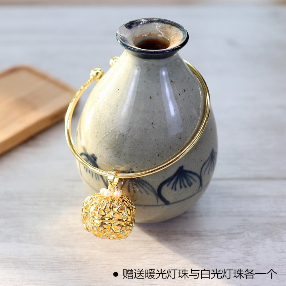 Boho vintage gold bangle with sakura locket charm, styled on wooden tray, ideal for bohemian and floral fashion enthusiasts 13