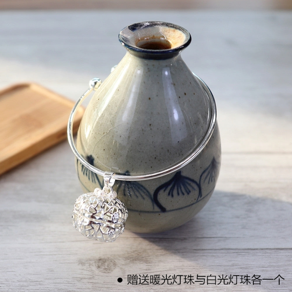 Boho vintage gold bangle with sakura locket charm, styled on wooden tray, ideal for bohemian and floral fashion enthusiasts 16