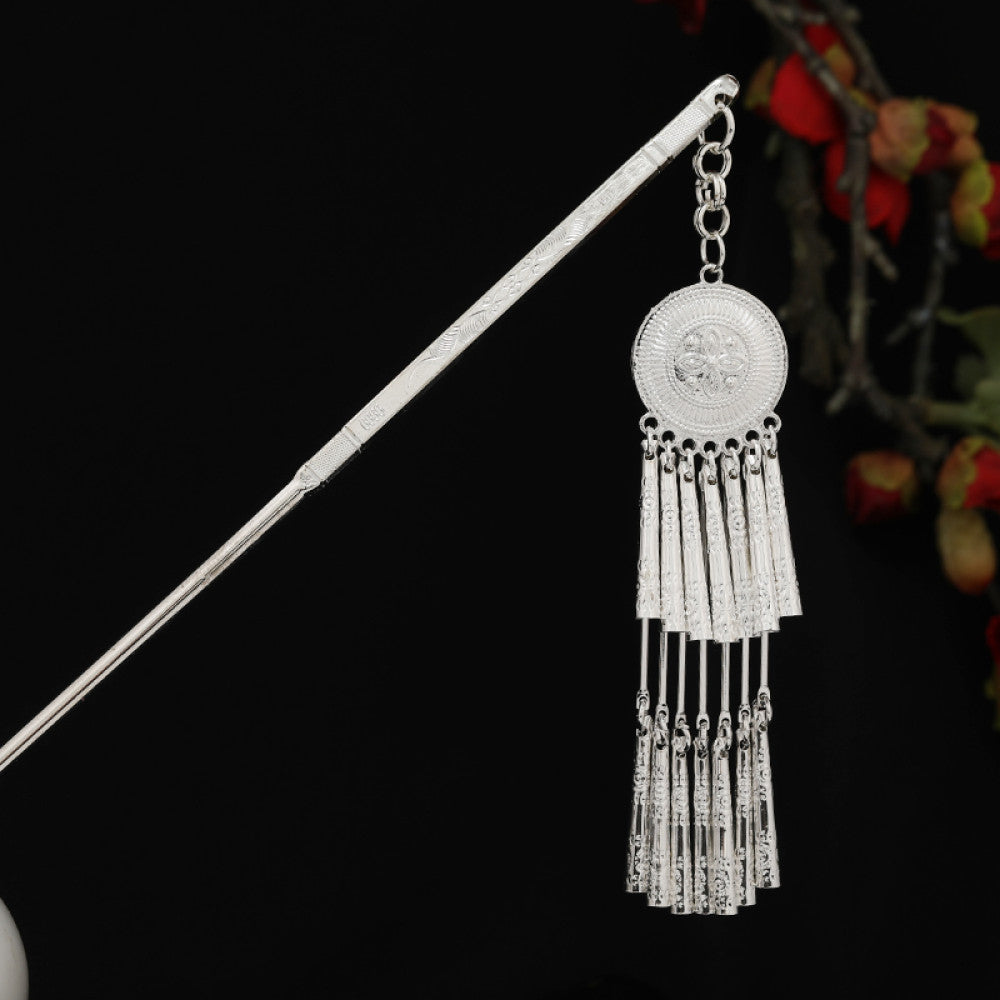 Boho vintage ethnic silver-tone hair stick featuring detailed textured handle, intricate chain network decor, and layered silver tassel pendants, displayed against a black background with red floral accents 15