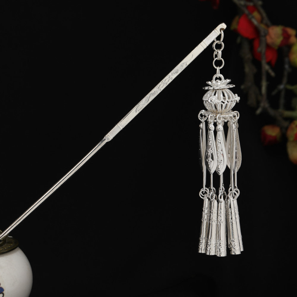 Boho vintage ethnic silver-tone hair stick featuring detailed textured handle, intricate chain network decor, and layered silver tassel pendants, displayed against a black background with red floral accents 16