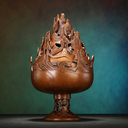 Intricate bronze Boshan-style Chinese incense burner with mountain-shaped pierced lid and dragon motifs, a Feng Shui symbol of wealth and elegance, displayed as a sophisticated home decor piece against a teal textured background