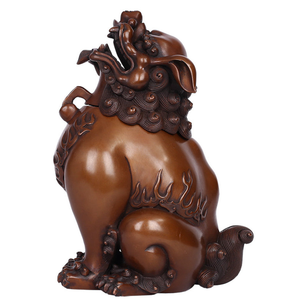 Intricate bronze Foo Dog incense burner with detailed carvings and flame motifs, a Feng Shui symbol of wealth and protection, displayed as elegant home decor against a white background