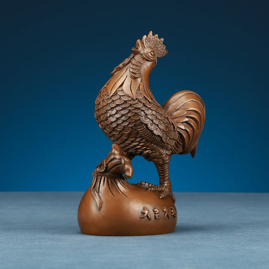 Intricate bronze rooster statue, a Feng Shui symbol of good fortune, displayed as elegant home decor against a blue background