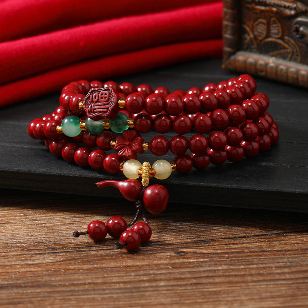 Solid red cinnabar beads with Vajra Bodhi accents, classic and elegant.
