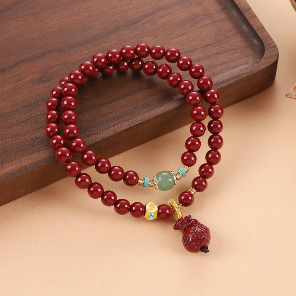 Fresh green chalcedony contrasts with deep red cinnabar, with a Vajra Bodhi tassel bringing a natural vibe
