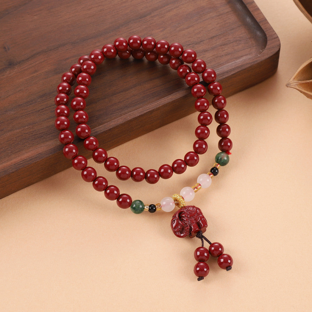 Colorful gemstones interspersed among cinnabar beads for rich layers, with a Vajra Bodhi pendant for a unique touch.