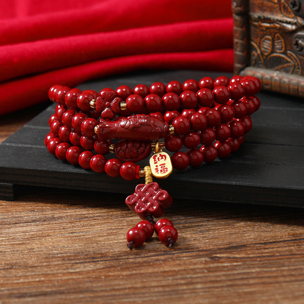 Red cinnabar beads with a tassel pendant, lively and eye-catching.