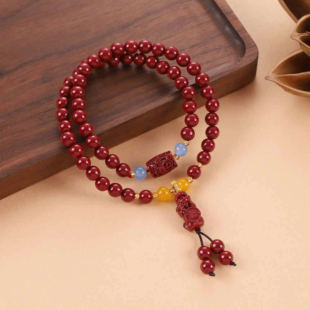 Deep red cinnabar beads paired with Vajra Bodhi and blue chalcedony, adorned with a Vajra Bodhi tassel for an elegant antique look.