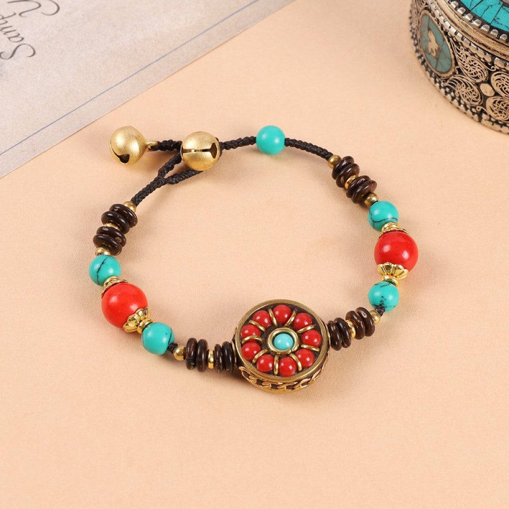 Bold red beads contrast with turquoise stones, unique bohemian look.