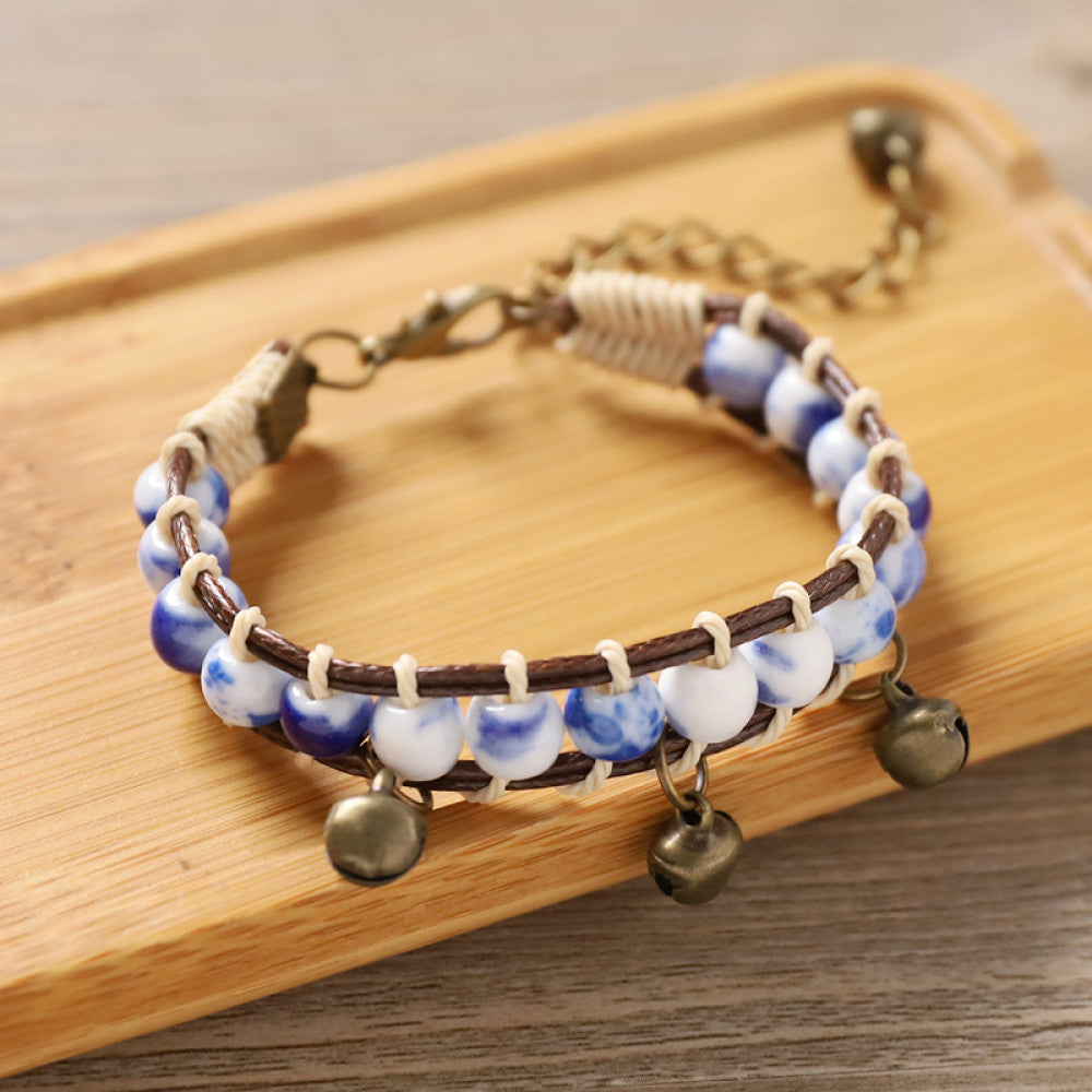 The adjustable design ensures a comfortable fit, adding a playful, earthy touch to any outfit.accented with small bronze bell charms
