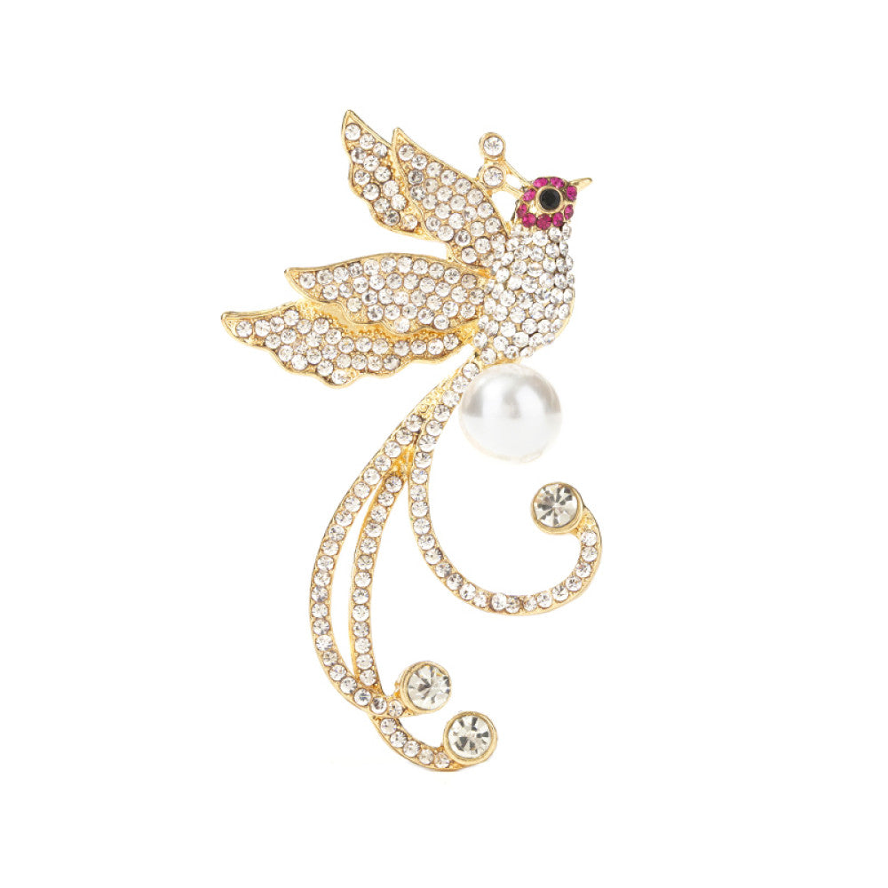 This elegant brooch features a sparkling crystal-encrusted bird in a gold-tone setting, accented by a lustrous pearl and delicate pink detail at its head. A sophisticated statement piece for any outfit 04