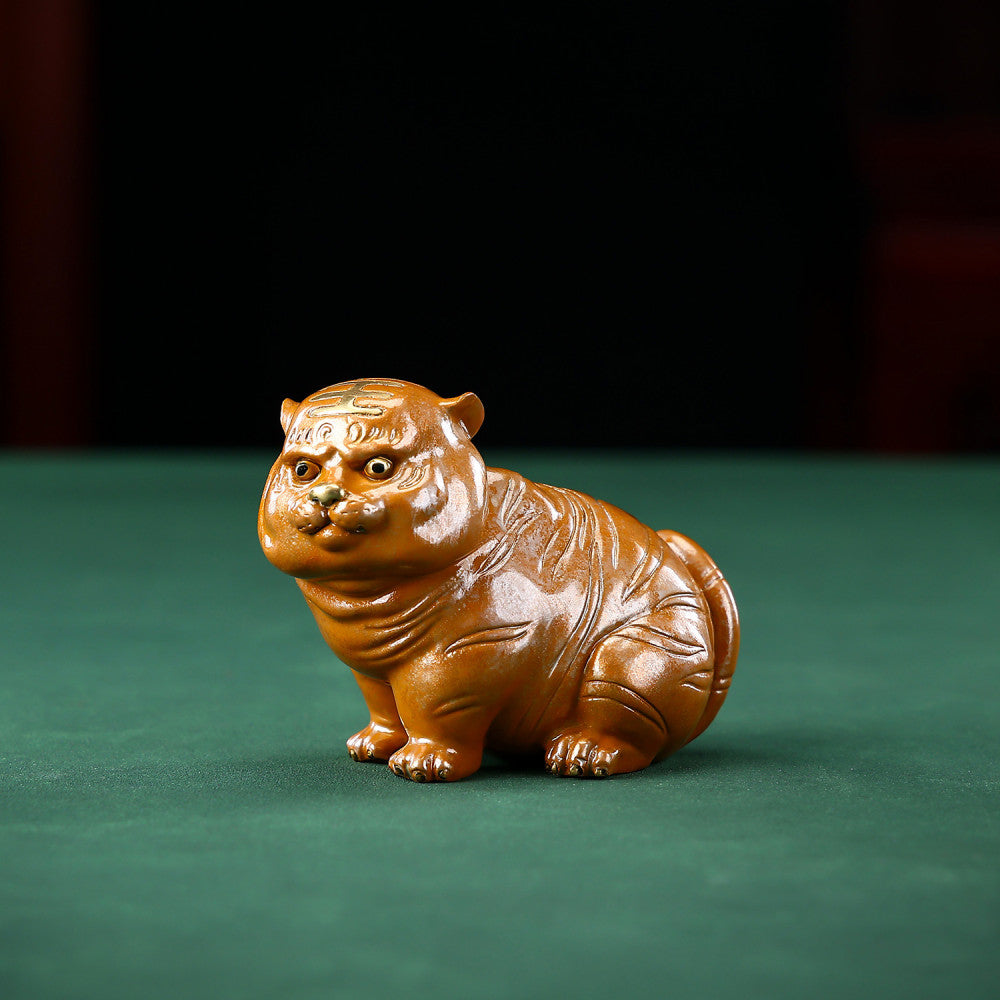 Cute brown chubby tiger figurine with intricate details, a symbol of good luck, placed on a green surface against a blue background 01