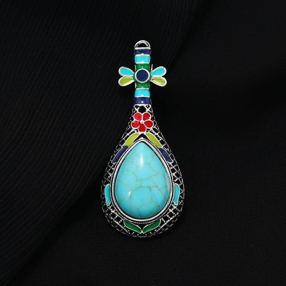 This exquisite brooch features a unique musical instrument-inspired design, crafted with intricate filigree metalwork and vibrant enamel accents. A large, warm amber-hued gemstone takes center stage, surrounded by colorful enamel details that add playful charm. The antiqued silver-tone base enhances its vintage appeal, making it a standout accessory for blazers, scarves, or special occasion outfits, blending artistic craftsmanship with timeless elegance. 02