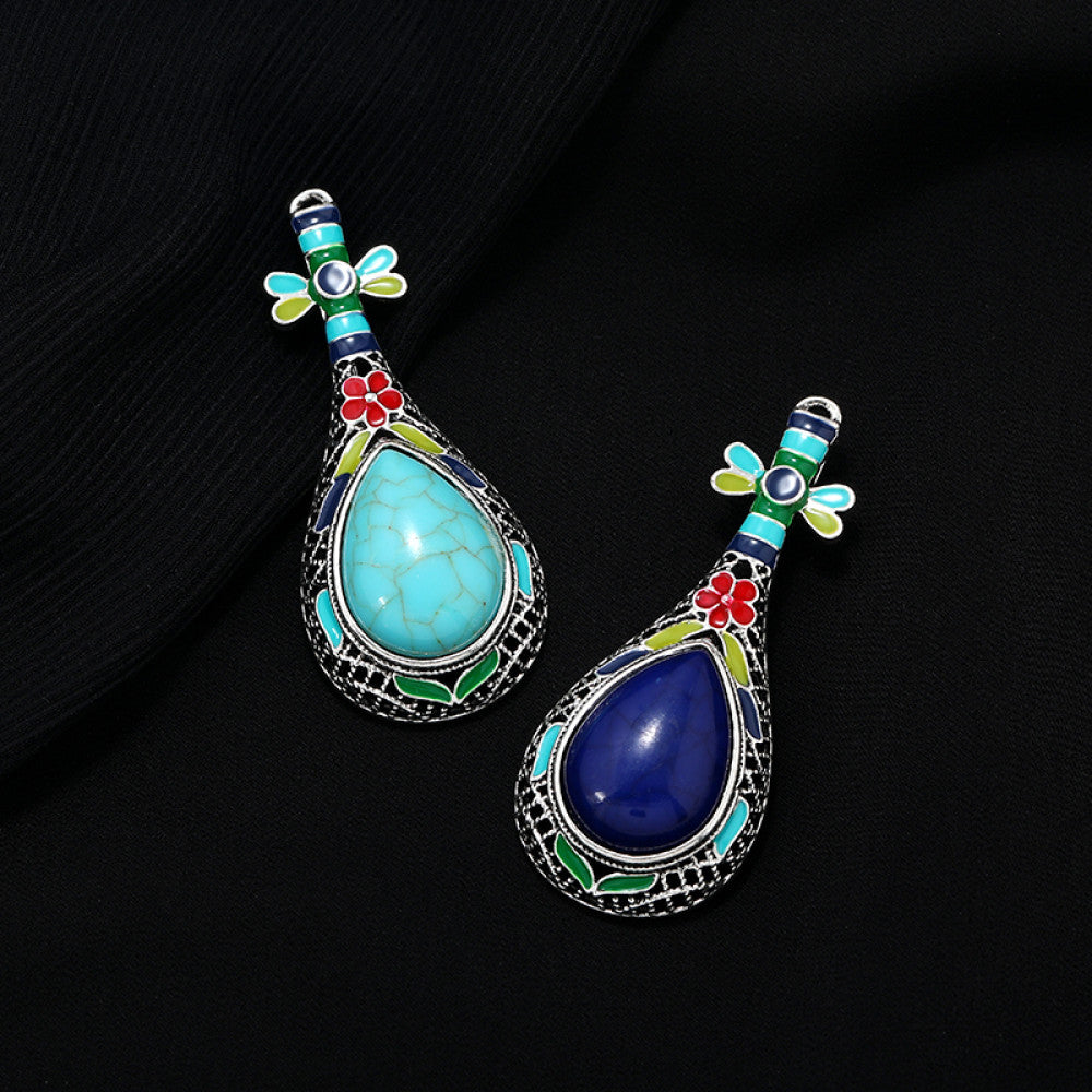 This exquisite brooch features a unique musical instrument-inspired design, crafted with intricate filigree metalwork and vibrant enamel accents. A large, warm amber-hued gemstone takes center stage, surrounded by colorful enamel details that add playful charm. The antiqued silver-tone base enhances its vintage appeal, making it a standout accessory for blazers, scarves, or special occasion outfits, blending artistic craftsmanship with timeless elegance. 04