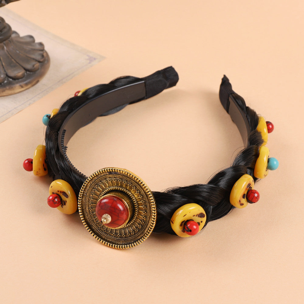 Boho vintage ethnic black braided hair hoop headband featuring a prominent gold ornament, plus red, turquoise, and yellow bead details