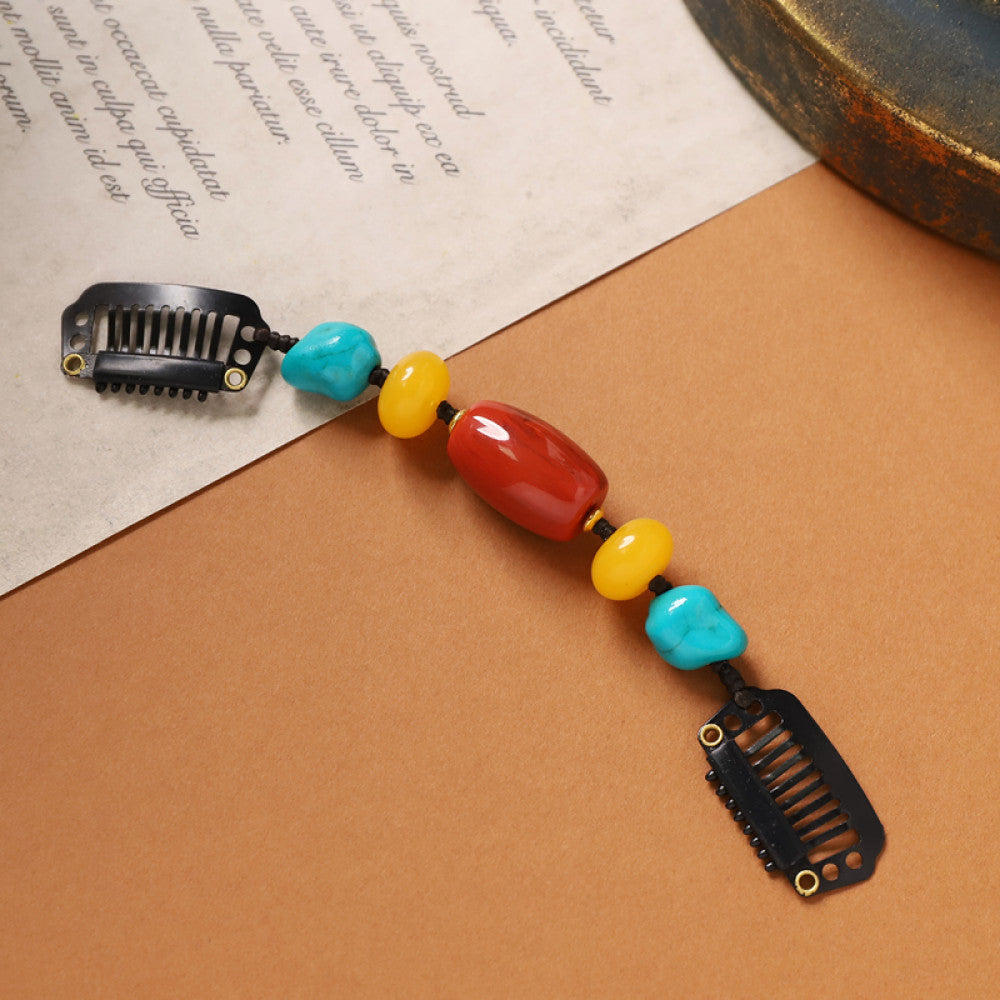 Boho vintage ethnic double hair comb ornament featuring an evil eye decorative bead, red/yellow beads, and black hair combs