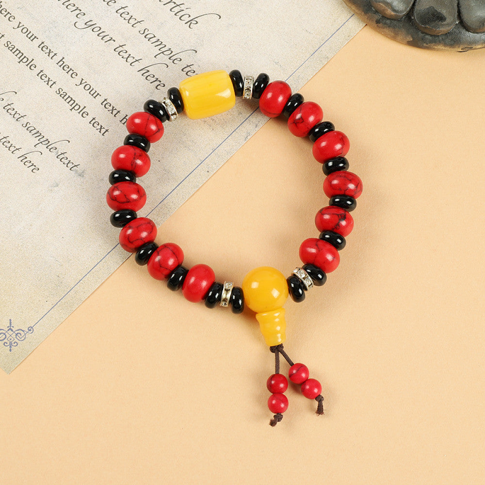 This ethnic-style bracelet features a mix of white, yellow, and red ceramic beads, accented with turquoise details and an adjustable tassel closure for a unique, cultural-inspired look 4