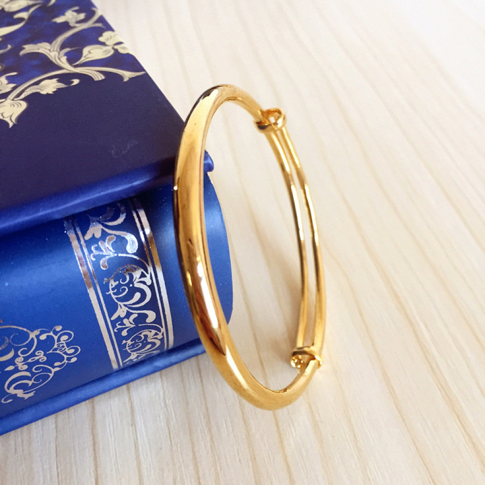 Fashion luxury engraved gold bangle, styled on a decorative black surface, ideal for elegant fashion enthusiasts in the US 01