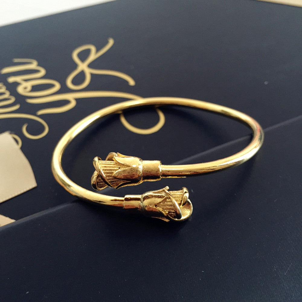 Fashion luxury engraved gold bangle, styled on a decorative black surface, ideal for elegant fashion enthusiasts in the US 05