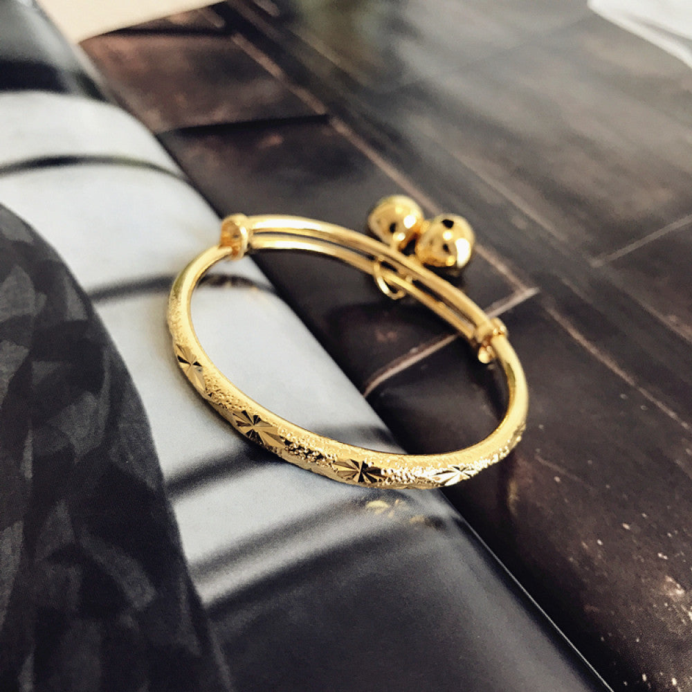 Fashion luxury engraved gold bangle, styled on a decorative black surface, ideal for elegant fashion enthusiasts in the US 06