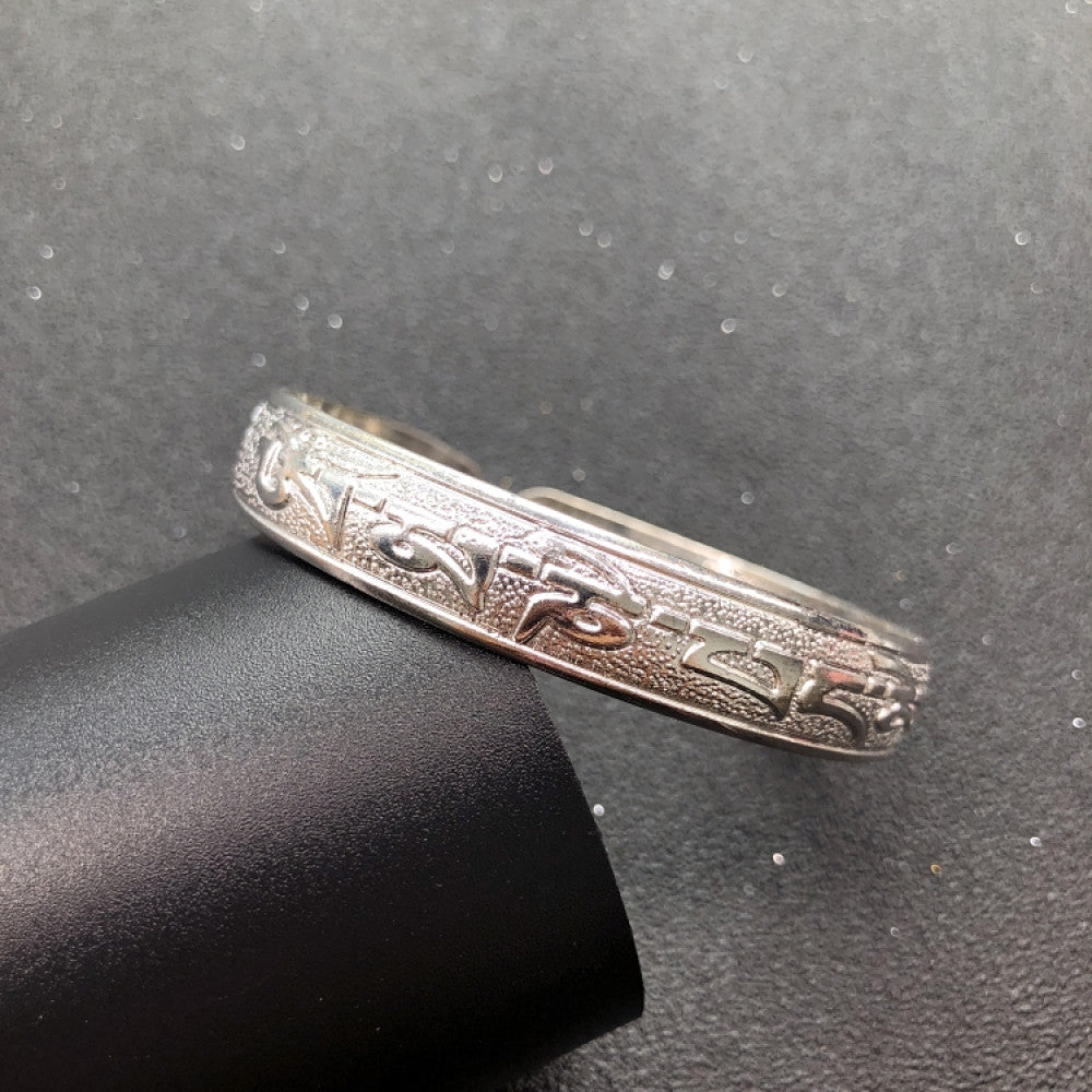 Fashion luxury love-inspired silver cuff bangle, styled on a sleek surface, ideal for elegant and trendy fashion enthusiasts in the US 01