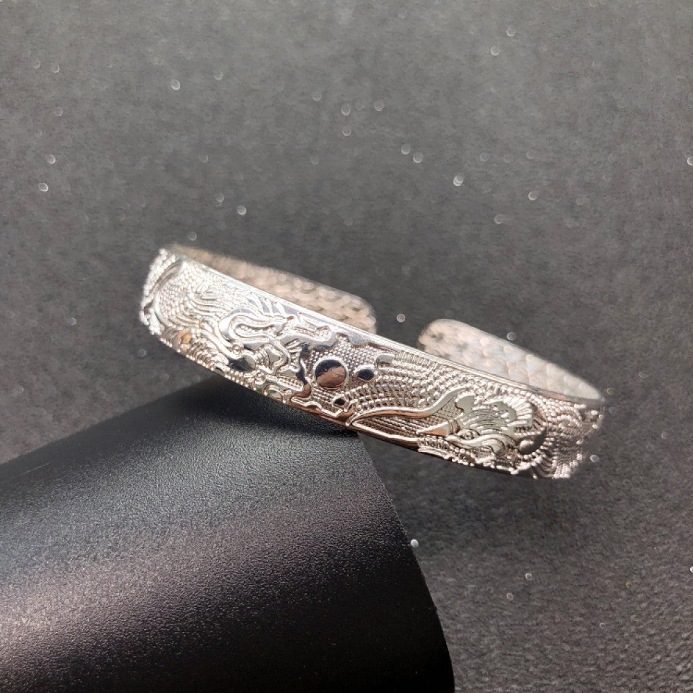 Fashion luxury love-inspired silver cuff bangle, styled on a sleek surface, ideal for elegant and trendy fashion enthusiasts in the US 02