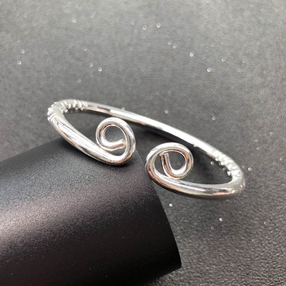 Fashion luxury love-inspired silver cuff bangle, styled on a sleek surface, ideal for elegant and trendy fashion enthusiasts in the US 05