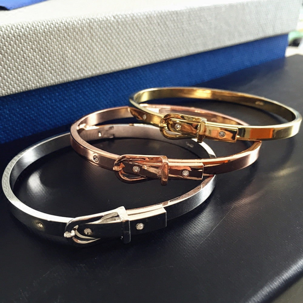 Fashion luxury multi-tone buckle bangle set in rose gold, silver, and gold, styled on a black surface, ideal for elegant fashion enthusiasts in the US