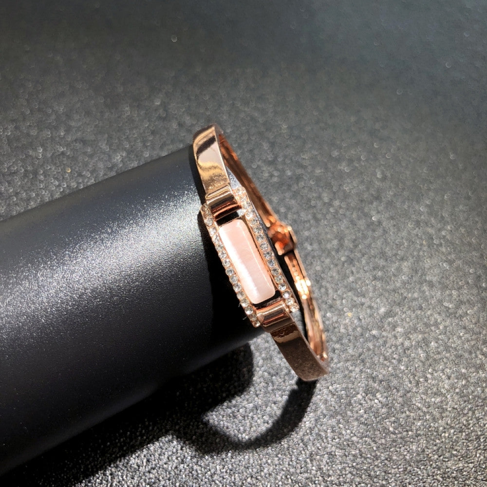 Fashion luxury rose gold bangle with heart-shaped diamond and intricate designs, displayed on black surface, ideal for luxury fashion and special occasion enthusiasts 01