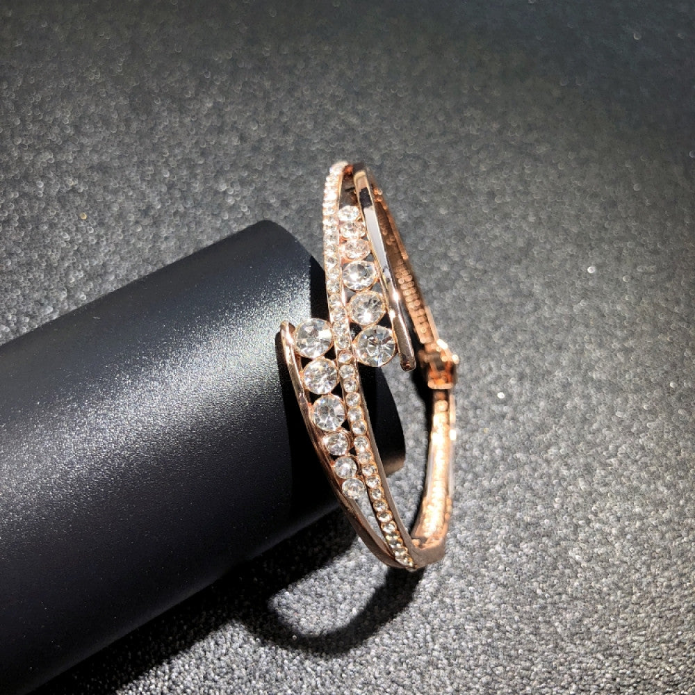 Fashion luxury rose gold bangle with heart-shaped diamond and intricate designs, displayed on black surface, ideal for luxury fashion and special occasion enthusiasts 02