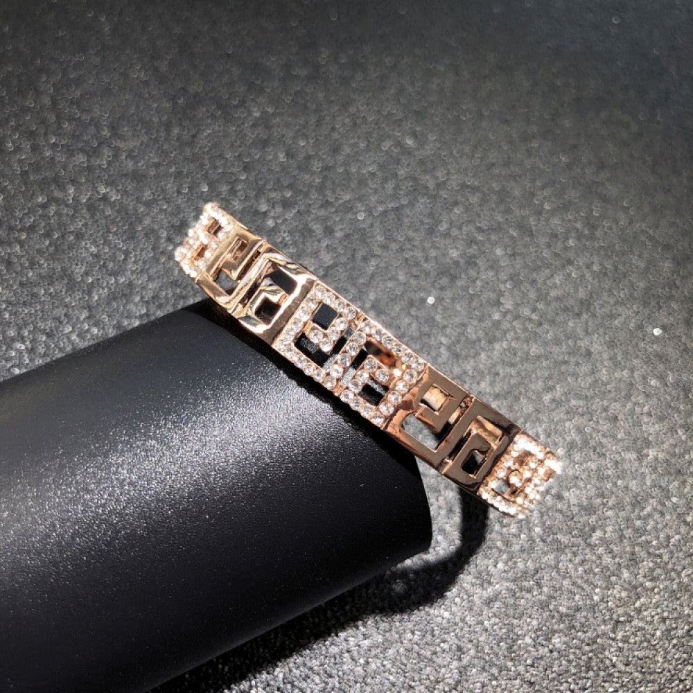 Fashion luxury rose gold bangle with heart-shaped diamond and intricate designs, displayed on black surface, ideal for luxury fashion and special occasion enthusiasts 03