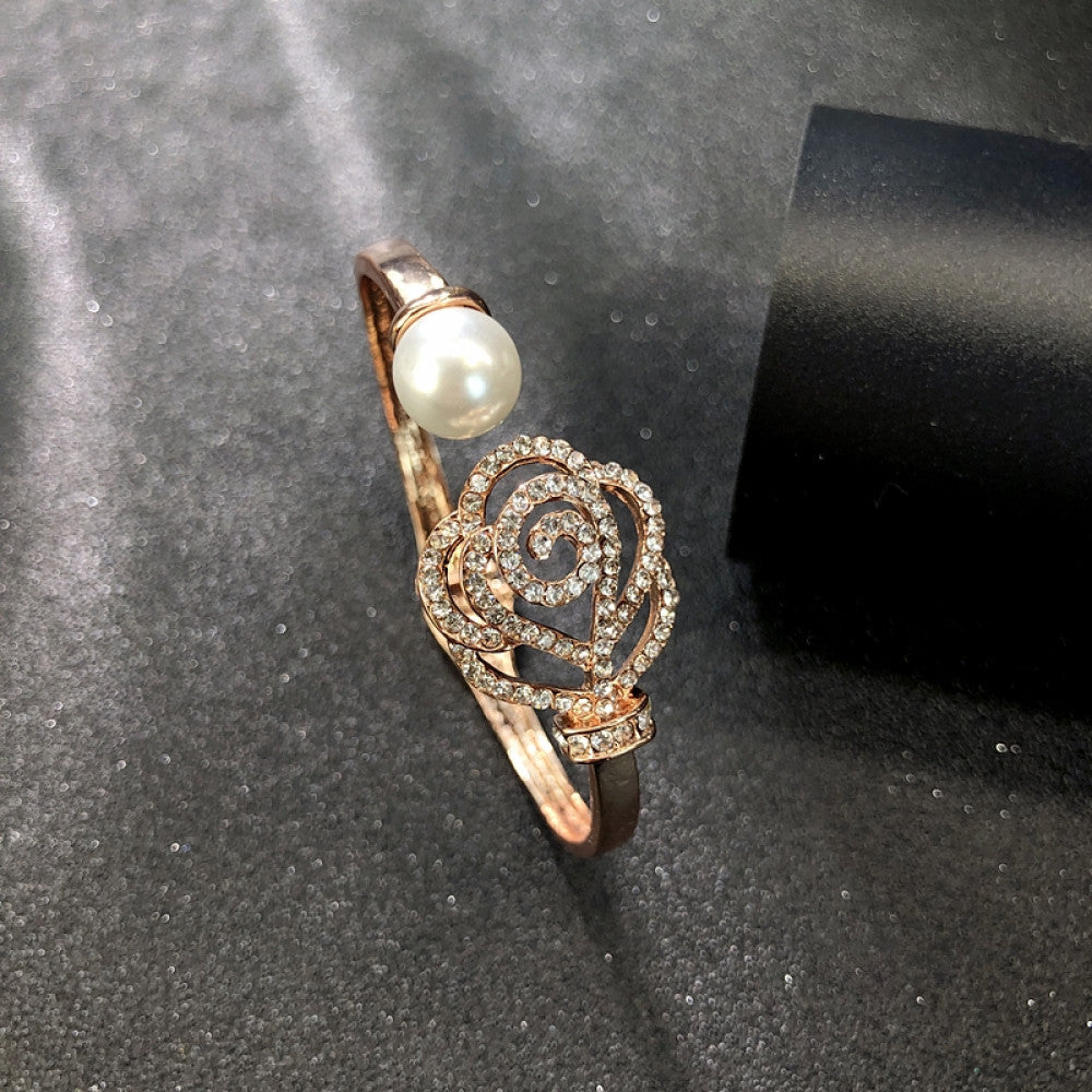 Fashion luxury rose gold bangle with heart-shaped diamond and intricate designs, displayed on black surface, ideal for luxury fashion and special occasion enthusiasts 08