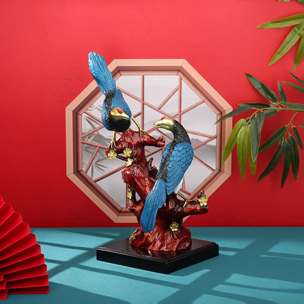Two colorful birds statue with intricate details, placed on a red branch - shaped base, set against a traditional Chinese octagonal window and red background (with a folding fan), ideal for feng shui home decor
