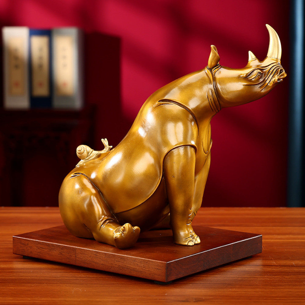 Golden rhino statue with intricate details, a symbol of good luck for home decor, set against a red background 03