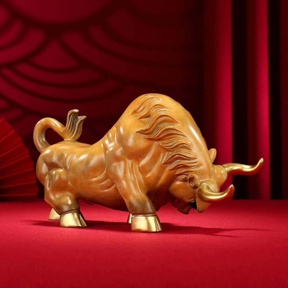 Golden bull statue with detailed craftsmanship, a symbol of strength and good fortune in Feng Shui, displayed as elegant home decor against a red background 01